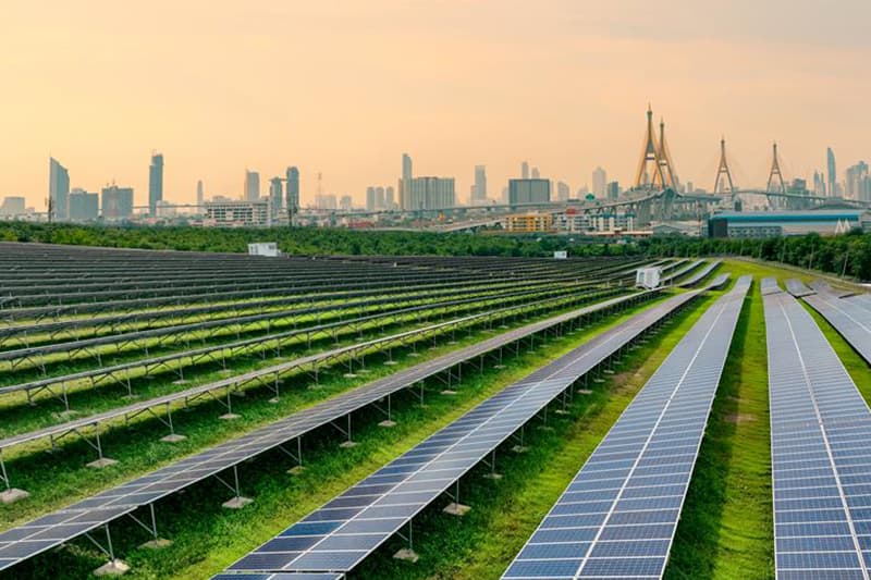 Solar panels with a city skyline in the background, symbolizing long-term ESG integration strategies, sustainable development, and renewable energy adoption