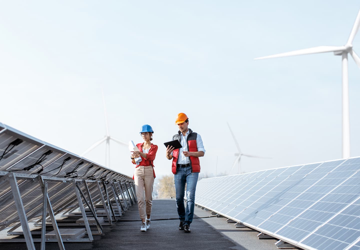 Professionals working near solar panels at a renewable energy site, symbolizing sustainable development, green transformation, and environmentally responsible business