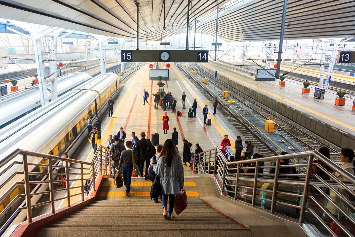 People moving through a modern transportation hub, symbolizing the development of corporate and organisational policies, process coordination, and strategic management