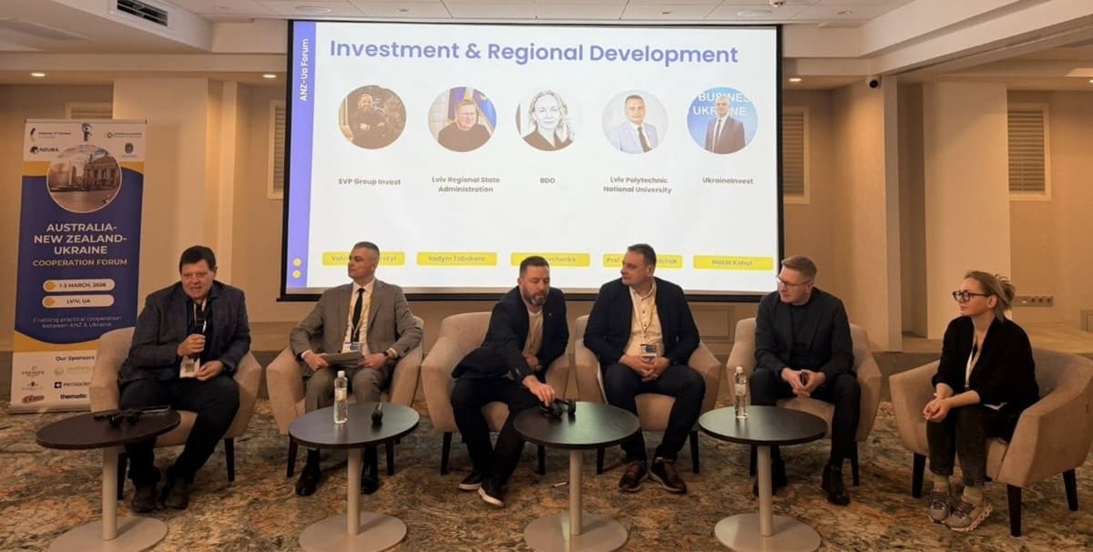 Panel Discussion at the Australia–New Zealand–Ukraine Forum: Investment and Regional Development Participants in a panel discussion at the Australia–New Zealand–Ukraine Forum, discussing investment and regional development in Ukraine. Speakers are shown against the backdrop of a presentation.